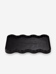 a black rectangular tray with wavy edges