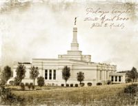 an old photo of a building with a flag on top and trees in the foreground