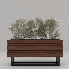 a wooden planter with two trees in it