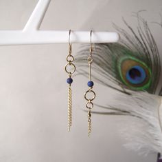 "These mismatched earrings are part of the \"Comète\" collection. They are created in gold-filled yellow gold and genuine Lapis Lazuli pearls. The fine dangling chains represent the tail of a comet hurtling along the edge of the universe... The combination of gold and the deep blue hue of Lapis Lazuli works beautifully.  They are asymmetrical to bring a touch of originality to the classic gold earrings.  This pair of earrings is also available in rose gold and white mother-of-pearl pearls, right here : https://www.etsy.com/fr/listing/1614520595/boucles-doreilles-asymetriques-et?click_key=b777fc9fb019e88954f0b046d089bada0a01e67b%3A1614520595&click_sum=50aeb6e5&ref=shop_home_active_1&frs=1 What is gold filled? It is a metal combining a brass base covered with a thick layer of gold, about 25 Cute Earring Ideas, Asymetrical Earrings, Mismatch Earrings, Edge Of The Universe, Diy Jewelry Earrings, Bijoux Fil Aluminium, Asymmetrical Earrings, Lapis Lazuli Beads, Mismatched Earrings