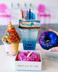 three donuts and two drinks on a table with a sign that says, sweet haze donut kill my vibe