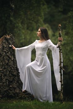 This white fairy dress is made of immaculate white fabric with cotton lace details on neckline, chest and sleeves. It has a silky linen, as well, and it closes with a zipper. It also can be very nicely accessorized with other medieval items like belts or corsets to obtain an unique outfit. This is custom-made to clients measurements and I require 2 weeks to finish it Please contact me for further assistance to discuss measurements and how to purchase a made to order outfit. I will be happy to answer all your questions. For orders to Europe, the package arrives in 5-7 days For orders to US, Canada the package arrives in 10-14 days Elegant White Medieval Dress For Larp, Medieval Style White Wedding Dress, White Fitted Elven Medieval Dress, White Bell Sleeve Wedding Dresses, Fairy White Dress, White Medieval Dress, Medieval Items, Maxi White Dress, Medieval Wedding Dress