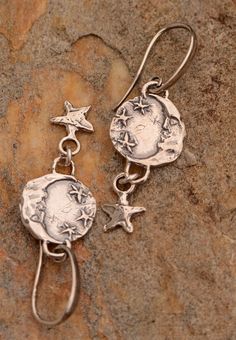 Super Cute Artisan Moon and Stars earrings! -Moon & Stars Charms measure 14mm each (26mm = 1") -Dangle Drop length is 29mm  -Overall length is 47.5mm -Available with Euro Style Lever Backs (.925) -These are sold as shown with Fancy Sterling Hooks.  These hooks are a little thicker than standard French Style hooks.  If you want thinner hooks, let us know ahead of your purchase.   We can also offer Euro Style Lever Backs. Silver Earrings Aesthetic, List Aesthetic, Thrift Wishlist, Stars Earrings, Upcycled Vintage Jewelry, Earring Inspo, Thrift Inspo, Pretty Ear Piercings, Earrings Moon