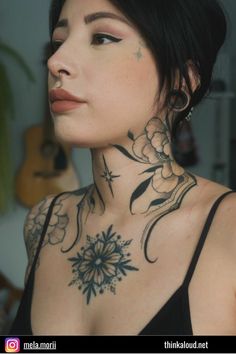 a woman with tattoos on her neck and chest