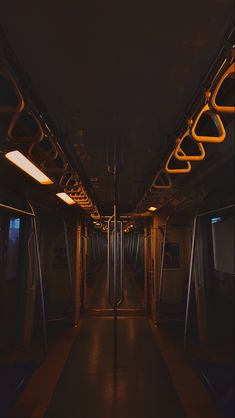 an empty subway car at night with its lights on