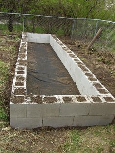 an empty concrete slab in the middle of a yard