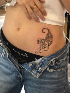 a woman with a tattoo on her stomach