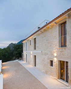 an exterior view of a stone house with lights on