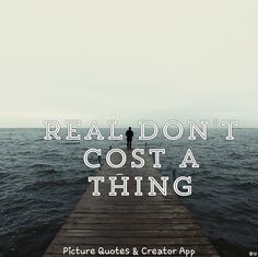 a person standing on a dock with the words real don't cost a thing