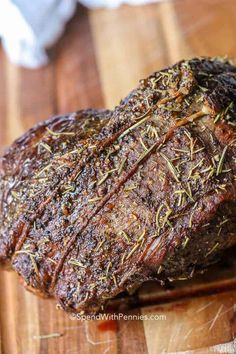 a piece of meat sitting on top of a wooden cutting board