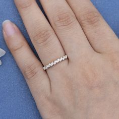 a woman's hand with a diamond ring on it