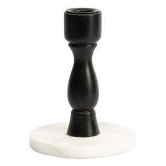 a black and white candle holder on a marble base