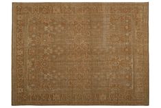 an antique rug with brown and beige colors