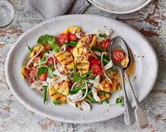 a white plate topped with pasta and vegetables