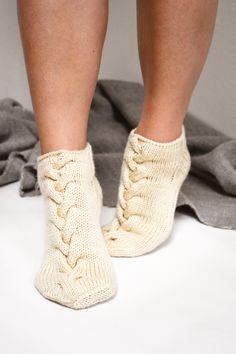 "Elegant hand-knit cable slipper socks that will perfectly suit your off days when lounging at home wrapped in one of our blanket shawls sipping your favorite beverage. Details: * Designed and made by us in our studio in Riga, Latvia using traditional techniques and thoughtfully sourced materials; * Hand knit from Peruvian Highland wool; * Suited for women; * Can be worn all-year-round; * Will keep you completely and thoroughly warm; * Does not have usually rough feel like regular wool; * Highly Fall Slippers, Cable Socks, Chunky Socks, Cable Knit Socks, House Socks, Bed Socks, Blanket Shawl, Hand Knit Socks, Ankle Socks Women