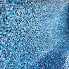 a blue tiled wall in a bathroom