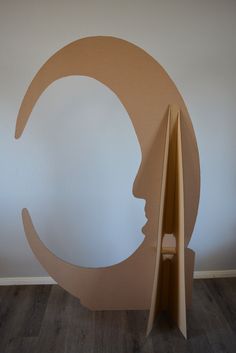 a cardboard cut out of a person's head in front of a white wall