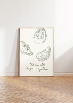 an art print with three oysters in green ink on a white wall next to a wooden floor