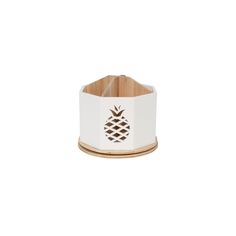 a white and wood pineapple napkin holder