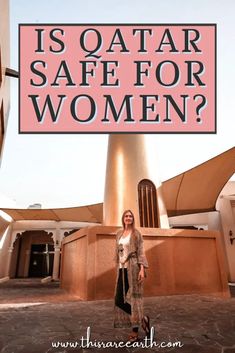 a woman standing in front of a building with the words is qatar safe for women?