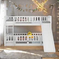 a white bunk bed with a slide next to it