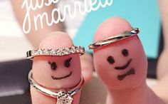 two fingers with smiley faces drawn on them and the words just married written above them