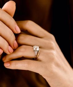 a close up of a person wearing a diamond ring