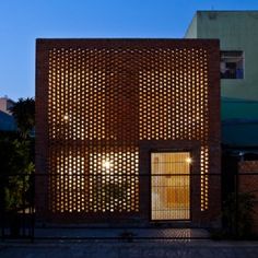 a brick building with an open door on the outside and light shining in through it