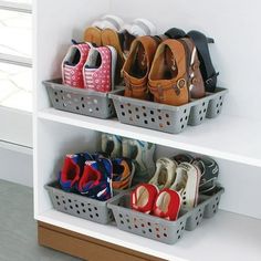 several pairs of shoes are sitting in baskets on the shelf next to another pair of shoes