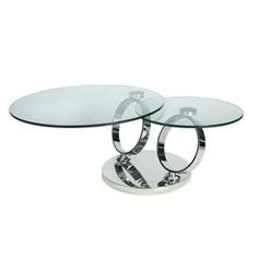 two glass tables with chrome bases and zebra print on the bottom one table is round