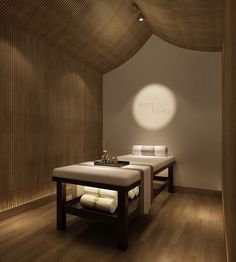 a spa room with two benches and towels on the tables