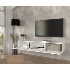 a flat screen tv mounted to the side of a wall in an empty living room