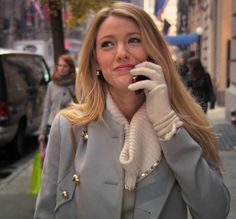 a woman talking on her cell phone while walking down the street