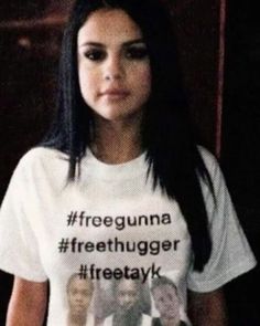 a woman wearing a t - shirt that says freegunna