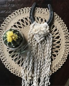 a white doily with some flowers and horns on it