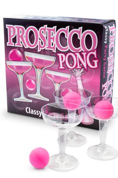 three wine glasses with pink balls in front of a boxed box for the game prosteco pong