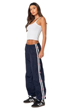 Get active in these sporty track pants designed with bow-trimmed stripes racing down the sides. Elastic waist Side-seam pockets 100% polyester Machine wash, dry flat Imported Casual Track Pants, Striped Track Pants Outfit, Sporty Adidas Bottoms With Side Stripes, Sporty Wide-leg Sweatpants With Three Stripes, Stripe Track Pants, Track Pants Adidas, Sporty Sweatpants With Contrast Stripes, Relaxed Fit, Navy Track Pants, Track Pants Outfit