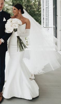 a bride and groom are standing on the porch