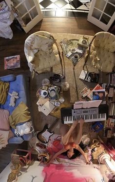 an overhead view of a bedroom with furniture and items on the floor, including a piano