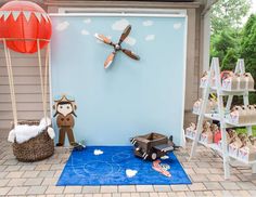 an outdoor area with toys and decorations on the ground, including a wall clock in the shape of a pirate ship