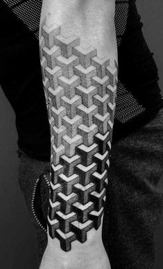 a man's arm with a black and white geometric pattern on it