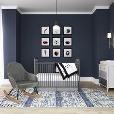 a baby's room with a rocking chair, crib and pictures on the wall