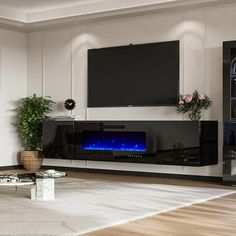 a living room with white walls and a large tv mounted on the wall next to a fireplace