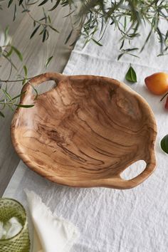 a wooden bowl sitting on top of a table