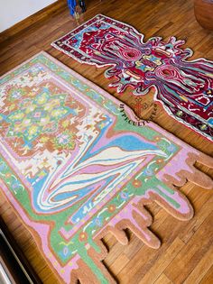 two rugs on the floor next to each other and one has an intricately designed design