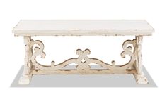 a white table with an ornate design on it's top and bottom shelf, against a white background