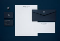 an assortment of stationery items including envelope, business cards and letterheads on a blue background