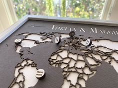 the world map is made out of metal and has buttons on it that read, marry & magic