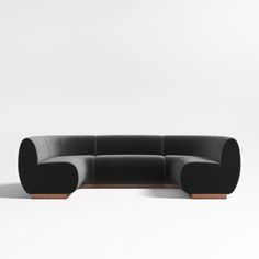 a black couch sitting on top of a white floor