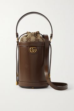 Gucci's beloved 'Ophidia' collection is defined by timeless silhouettes and signature details. Crafted in Italy from smooth leather, this bucket bag is embellished with the iconic gold-tone 'GG' hardware and lined with a monogrammed canvas-jacquard pouch that secures with drawstring ties. Carry yours by the top handle or shoulder strap. Luxury Trendy Baguette Bag For Party, Luxury Elegant Satchel With Single Shoulder Strap, Gucci Bucket Bags, Luxury Leather Bucket Bag, Luxury Chic Satchel Baguette Bag, Luxury Leather-handled Baguette Bag For Formal Occasions, Luxury Miu Miu Shoulder Bag For Daily Use, Luxury Baguette Bag With Metal Hardware For Women, Luxury Baguette Bag With Multiple Compartments For Daily Use